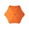 An orange BLUNT Classic Umbrella with a star-shaped canopy design and a central point. It features a logo.