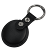 A black tracking tag with a keyring attached, featuring a leather case and metal snap.