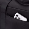 A black duffel bag features a zippered pocket with a smartphone partially visible inside.