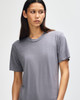 A grey American Apparel tri-blend T-shirt with a relaxed fit, featuring a subtle branding logo.