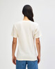 A cream-coloured American Apparel tri-blend T-shirt, viewed from the back, featuring a simple design and relaxed fit.