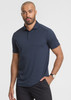 A short sleeve polo shirt in navy blue, featuring a collar and a logo on the chest, worn by a male model.