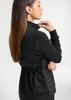 A women's black tailor jacket with a cinched waist, featuring a sleek design and a logo on the back.
