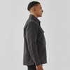 A men's black oxide Sherpa lined canvas jacket with a collar and side pocket, shown from a profile view.