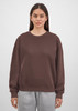 A brown crew sweatshirt for women, featuring a relaxed fit and long sleeves, displayed on a model.