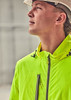 A vibrant yellow packable rain jacket is worn by a person looking upwards, complemented by a hard hat.