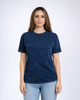 A woman models a navy blue Colortone® Mineral Wash adult t-shirt. The shirt has a rounded neckline and short sleeves.