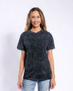 A woman models a black mineral wash adult T-shirt, featuring a casual fit and a subtle distressed look.