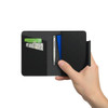 A black passport holder is shown, holding credit cards and a pen inside. It features a sleek, minimalist design.
