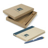 A tan notebook with a navy stripe and a blue pen, presented in a matching gift box. The box has a logo.