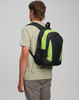 A black and lime green backpack is worn by a person from behind, showcasing its design and colour contrast.