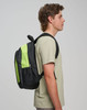 A black and lime green backpack displayed on a model, featuring a side view and a branded logo.