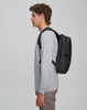 A black Elite PU backpack is shown worn on the back of a person in a grey long-sleeve shirt.