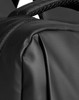 A close-up of a textured black backpack, featuring stitching and straps, with branding visible.