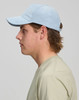 A light blue Jacquard Texture 5 Panel Cap shown on a model's head, featuring a branding logo on the side.