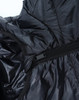 A close-up of a lightweight hooded puffer jacket in black, showcasing its zipper and inner lining.