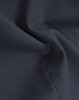 A close-up of navy cotton blend fabric, highlighting a textured weave with subtle folds.