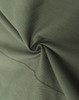 A close-up of dark green cotton blend fabric, showcasing its texture and softness. The material is smoothly folded.