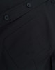 A close-up of a black cotton blend shirt featuring buttons and a pocket detail.