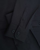 A black ladies' shirt featuring long sleeves and button details, showcasing a cotton blend fabric.