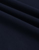A close-up of navy ultrafine cotton pique fabric, showcasing its texture and weave.