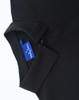A black polo shirt featuring a collar and a tag, showcasing a sleek, high-performance design.