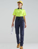A pair of navy work pants with a flexible fit, worn with a fluorescent yellow polo shirt and a hard hat.