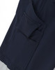 A close-up of navy blue work pants featuring multiple utility pockets and a branding logo.