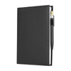 A black leather refillable journal with a pen attached, featuring a smooth cover and visible stitching.
