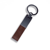 A brown PU strap keyring with a metallic attachment and circular keyring.