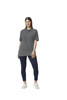 A woman stands wearing a grey Gildan Hammer Adult Double Pique Polo with a casual fit and navy pants.