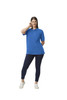 A woman poses in a bright blue Gildan Hammer Adult Double Pique Polo, paired with navy leggings and white sneakers.