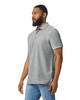 A grey Gildan Hammer Adult Double Pique Polo, featuring a collar and short sleeves, worn by a man.