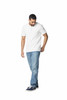 A man in a white polo shirt and blue jeans stands casually, wearing navy shoes. The shirt features a logo.