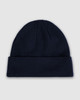 A navy blue watch cap featuring a folded cuff and a textured knit design. It includes a logo.