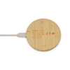 A round bamboo wireless charger with a white charging cable connected. It features a minimal design and has a logo.