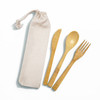 A bamboo cutlery set featuring a fork, knife, and spoon in a calico pouch. The cutlery is light brown, and the pouch is beige.