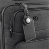 A black luggage tag with an AirTag holder attached to a grey suitcase, featuring a logo on the suitcase.