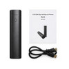 A black cylindrical power bank with a user guide and a USB cable. The power bank features an indicator light.