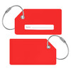 A red silicon luggage tag with a white name label and silver wire loop for attachment.