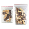 A clear bag containing various wooden game pieces, including brown and beige tokens, dice, and chess-like figures.