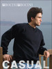 A black unisex crew neck fleece sweater worn by a man, positioned by a wooden railing near water. The image includes a logo.