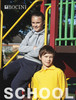 Kids in a playground wearing a grey hoodie and navy double-knee track pants, with a bright yellow polo shirt.