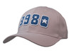 A beige cap featuring blue embroidered numbers and a star, with a logo on the side.