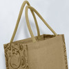 A jute tote bag in a natural beige colour with twin handles and a patterned side design. It's unbranded.