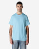 A light blue Gildan cotton t-shirt worn by a model, featuring a simple design and a logo.