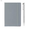 A grey A5 notebook with a matching elastic band and a silver pen beside it. The notebook features a logo on the cover.