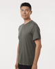 A man models a grey Men's Pro-Lock Performance Polo shirt, featuring a logo on the chest.