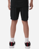 A person wearing black sports shorts and black athletic shoes, viewed from the back. The shorts have a sporty design.