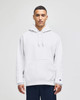 A grey hooded sweatshirt with a front pocket, featuring a logo on the sleeve, worn by a model.